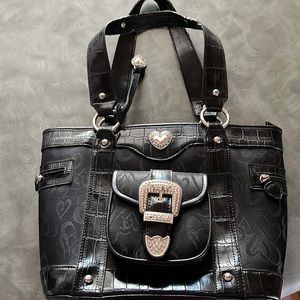 Black purse with silver accents. Nylon material with leather trim
